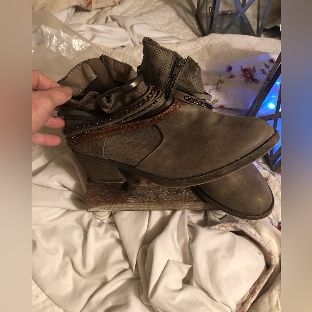 Ankle boots with cute leather straps around the top of them